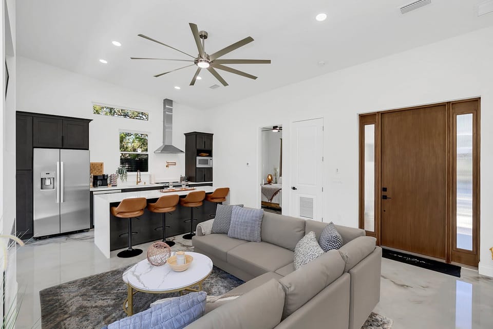 Modern open kitchen with a large island and seating for four.