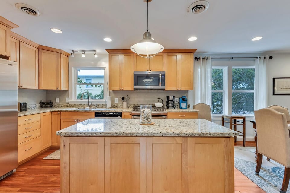 Your fully equipped kitchen awaits with granite counters, modern appliances, and a spacious island perfect for cooking meals together.
