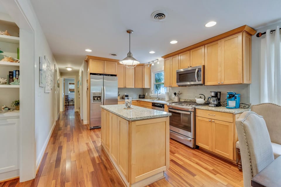 Your spacious kitchen features granite counters, stainless appliances, and a center island perfect for preparing memorable meals during your stay.