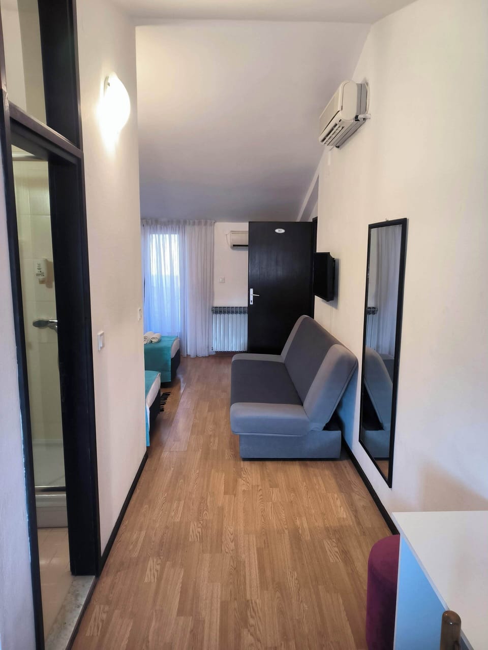 Classic Triple Room, Courtyard View | Living area | TV