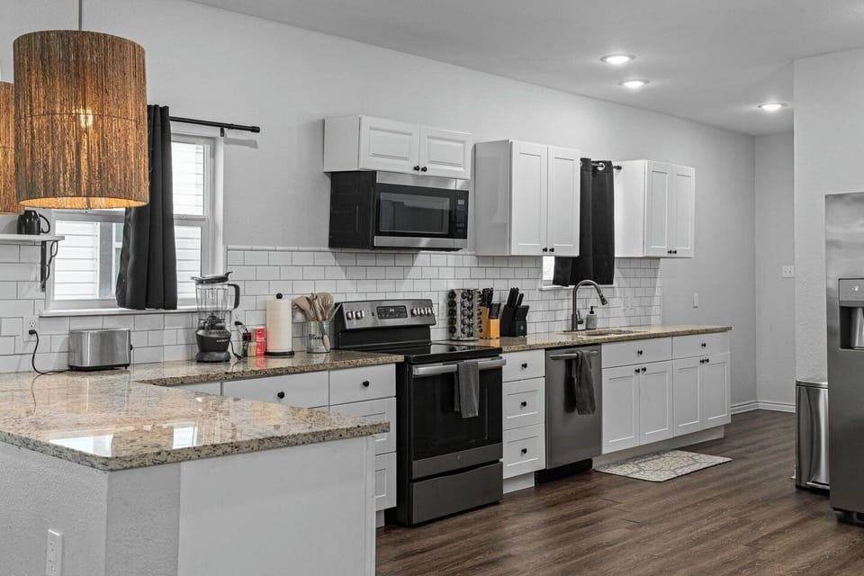 Bright modern kitchen with granite counters and stainless steel appliances