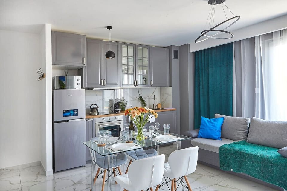Living room with dining table and sofa bed - book now with Rentujemy.com
