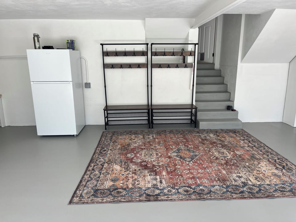 Mudroom entrance with additional refrigerator and storage. 