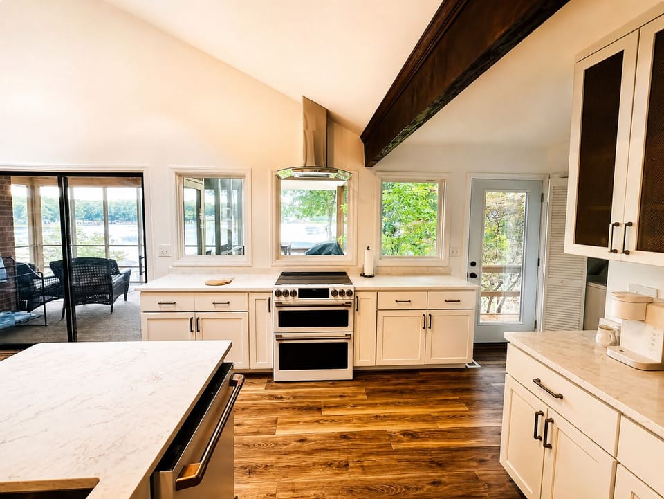 Fully stocked kitchen with high-end appliances and direct lake views.