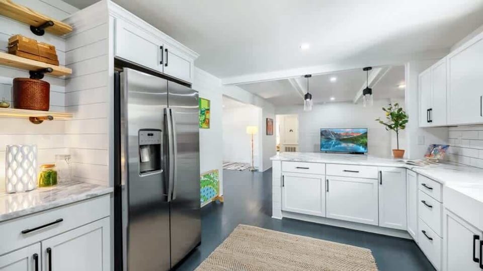Sleek, open kitchen with stainless steel appliances and plenty of counter space.