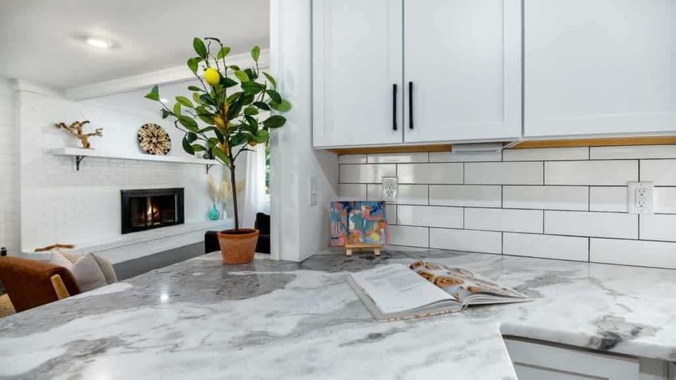 Kitchen accompanied with quartz countertops and updated backsplash.