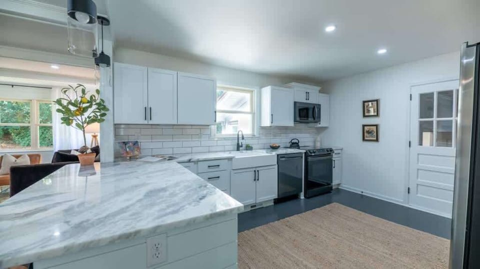 Sleek, open kitchen with stainless steel appliances and plenty of counter space.