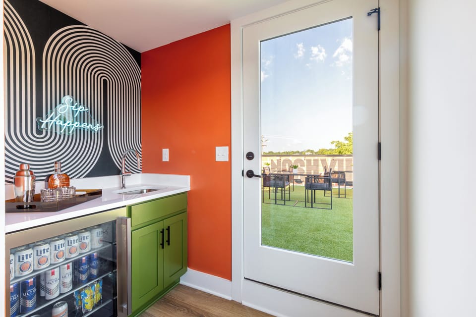 Indoor wet bar w/ beverage cooler & neon sign—because, after all, ‘sip happens.’