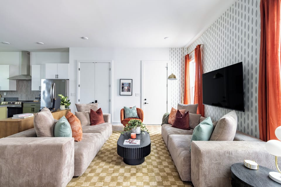 Cozy living room with 65" Smart TV and record player.