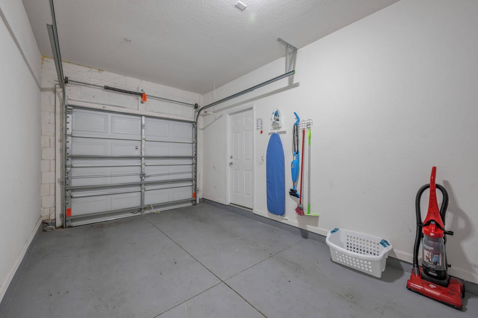 Laundry room with full size washer and dryer in the garage