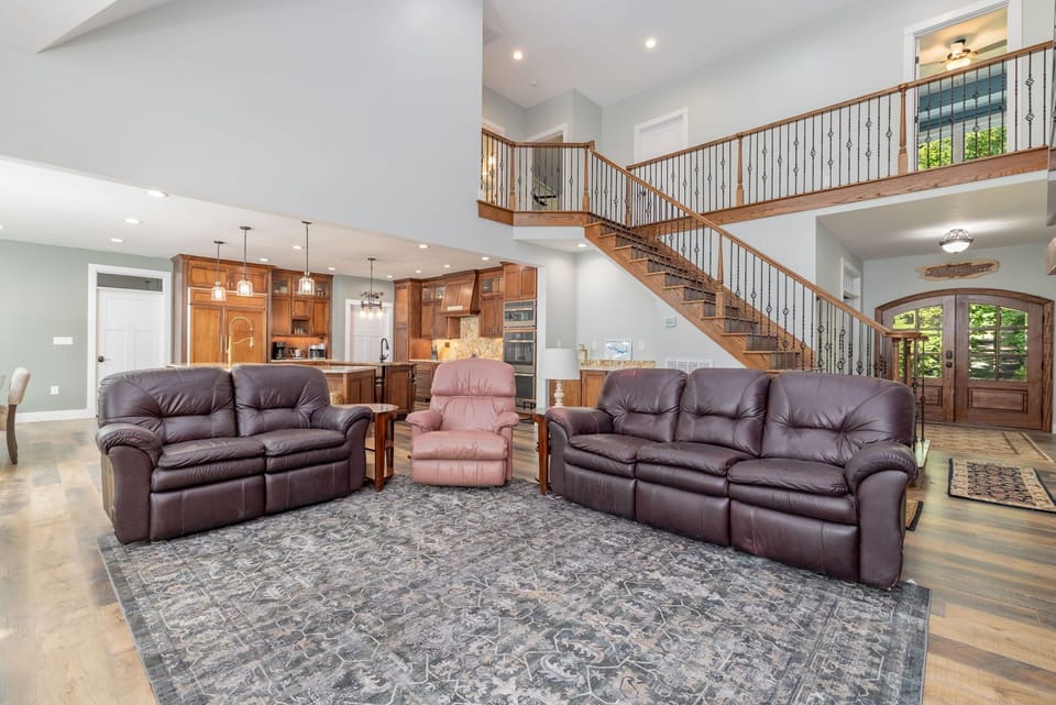 Spacious living room with leather seating & lake views