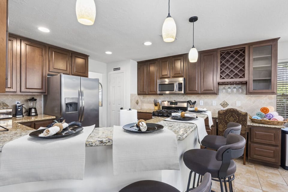 Large kitchen island with bar seating offers extra space for casual meals, snacks, or morning coffee.