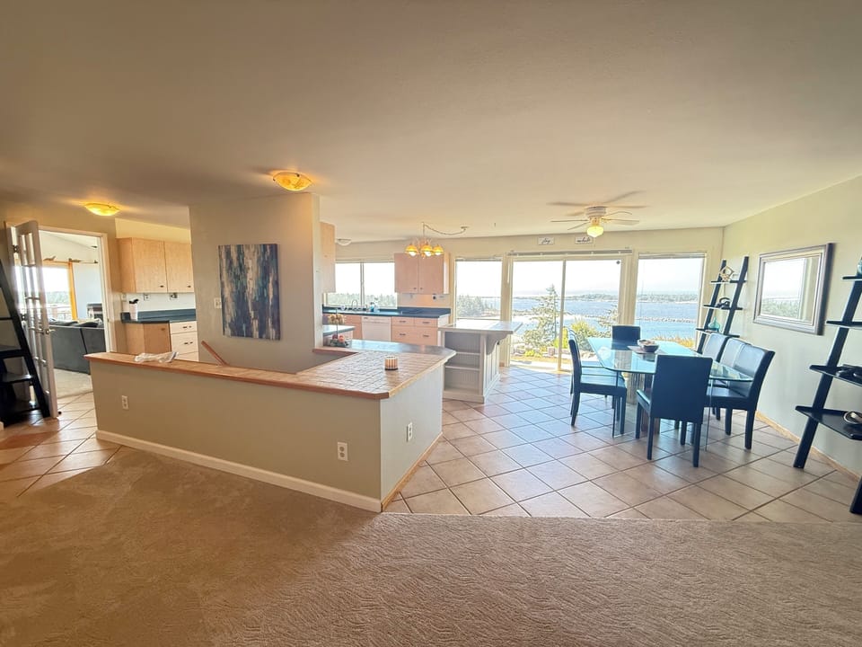 Dining Room and Kitchen with Sliding Glass Door to Backyard and Hot Tub