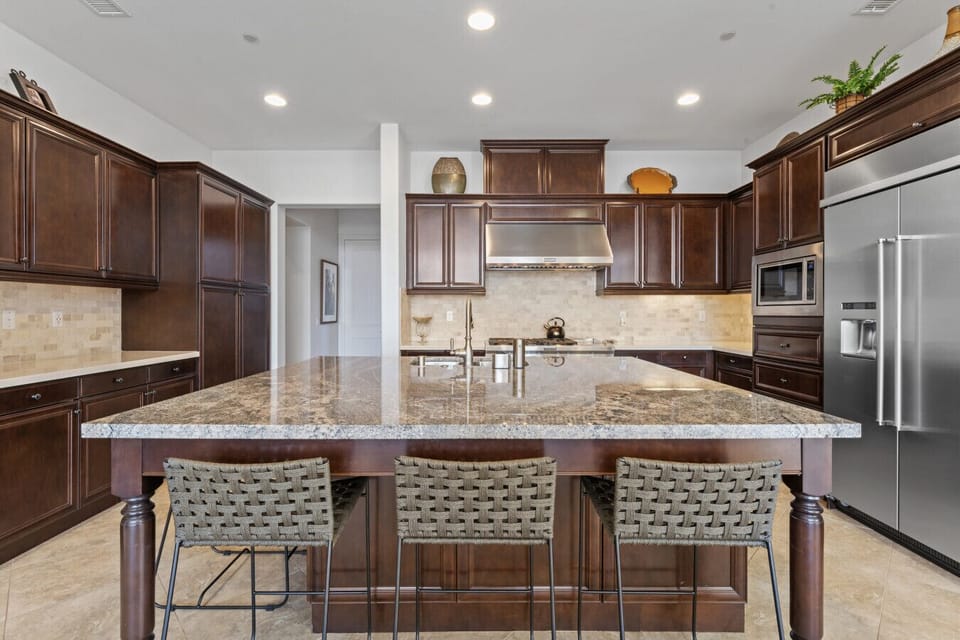 Chef-style kitchen w/ wraparound counters, bar seating & plenty of prep space