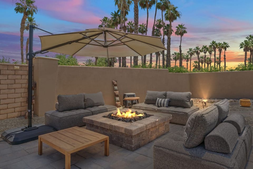 Cozy firepit lounge w/ cushioned seating, perfect for unwinding under desert skies
