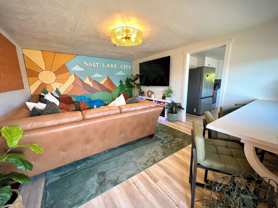View of the bar seating and living room as you walk into the house.  75 inch TV.