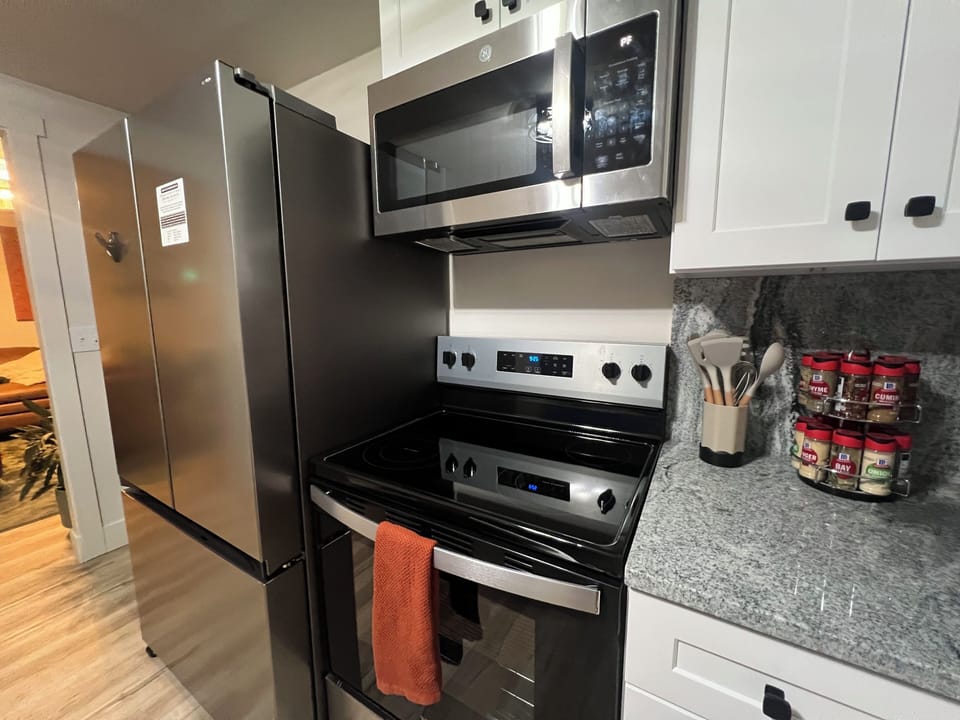 Full sized electric stove, oven, microwave, and fridge. Fridge with 2 ice sizes.
