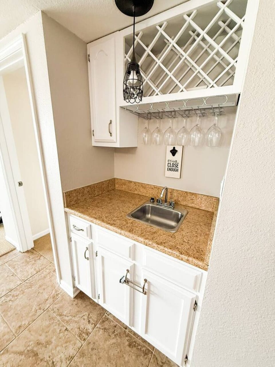 Convenient wet bar with sink and wine storage.
