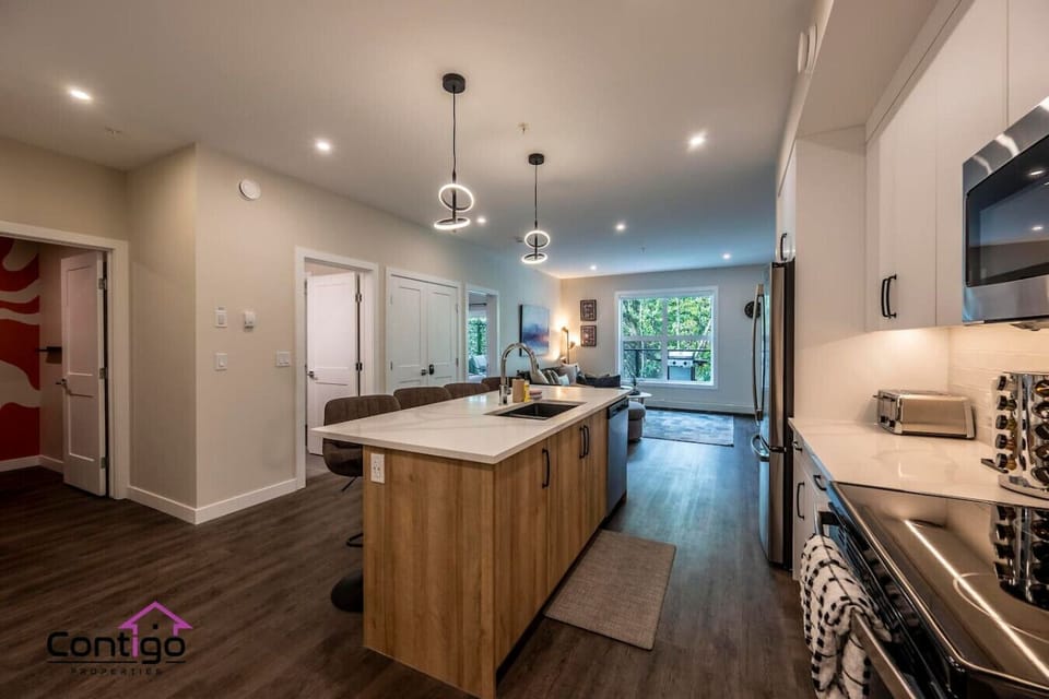 Sleek and functional kitchen with island seating, stainless steel appliances, and open-concept layout perfect for home-cooked meals.