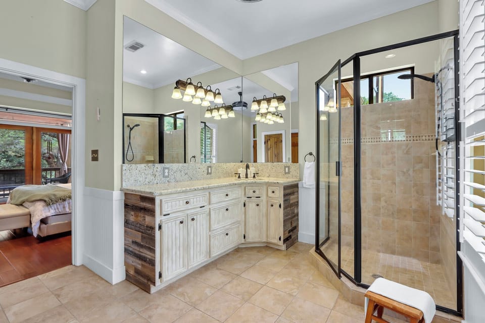 The bathroom has a walk in shower