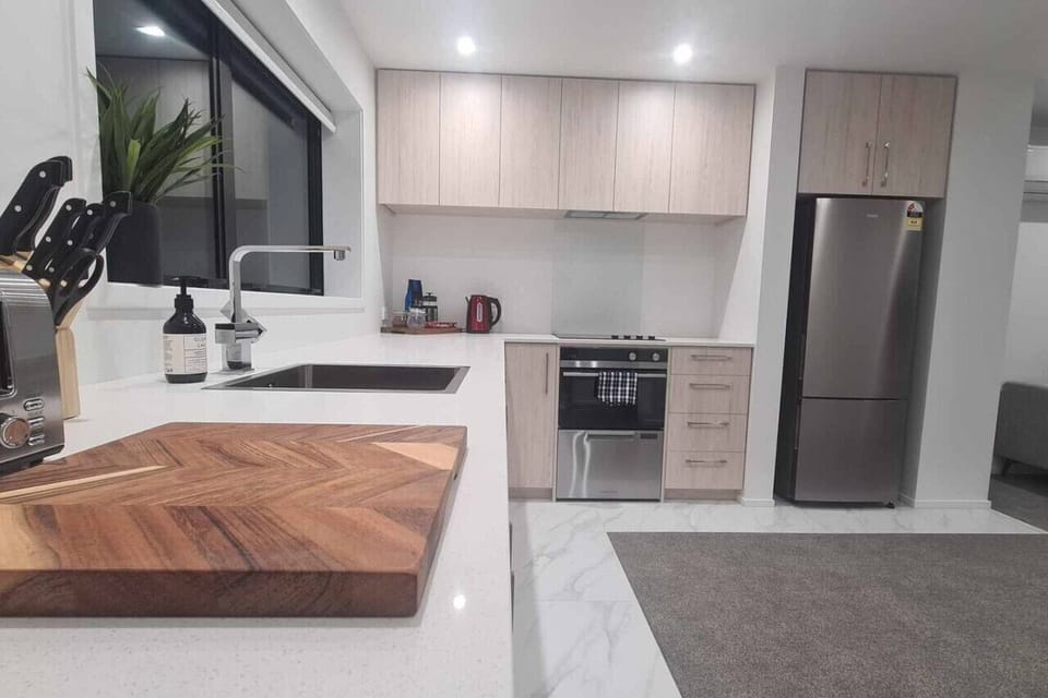 Fully equipped kitchen featuring a built-in oven, stovetop, cookware, and all the essentials for home cooking.