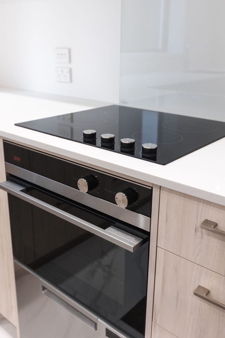 Fully equipped kitchen featuring a built-in oven, stovetop, cookware, and all the essentials for home cooking.