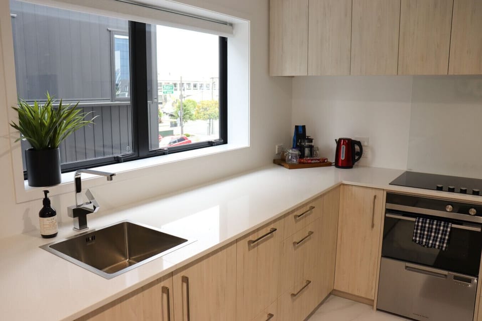 Fully equipped kitchen featuring a built-in oven, stovetop, cookware, and all the essentials for home cooking.