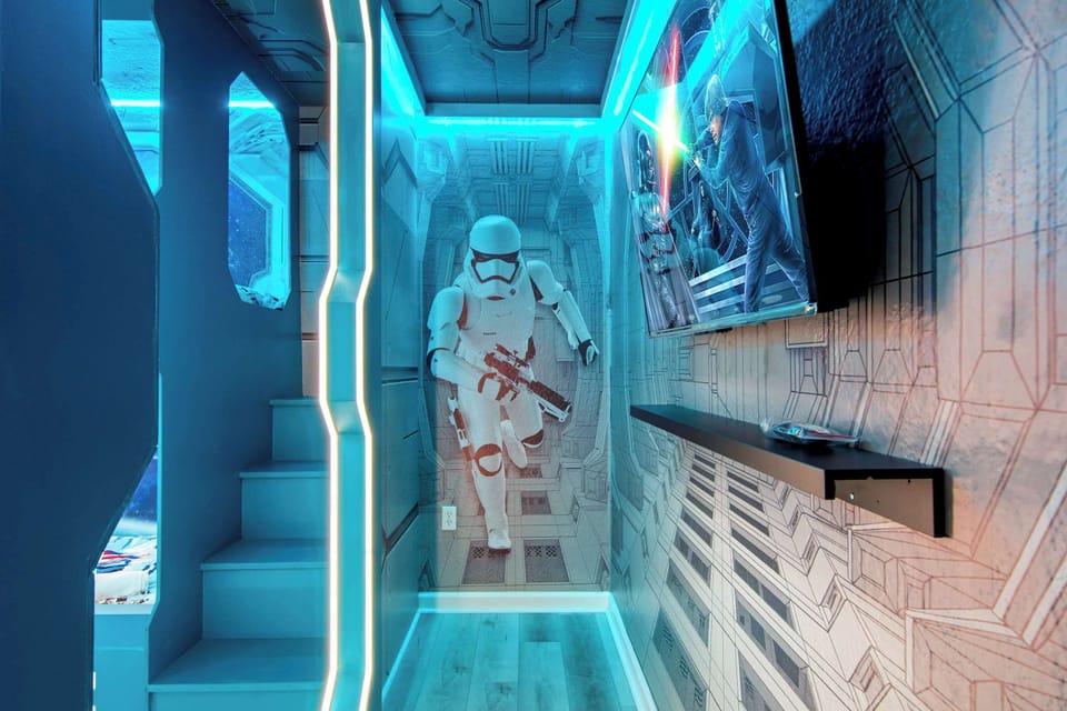 Sci-fi hallway with neon light, spaceship walls, and a dedicated TV niche.