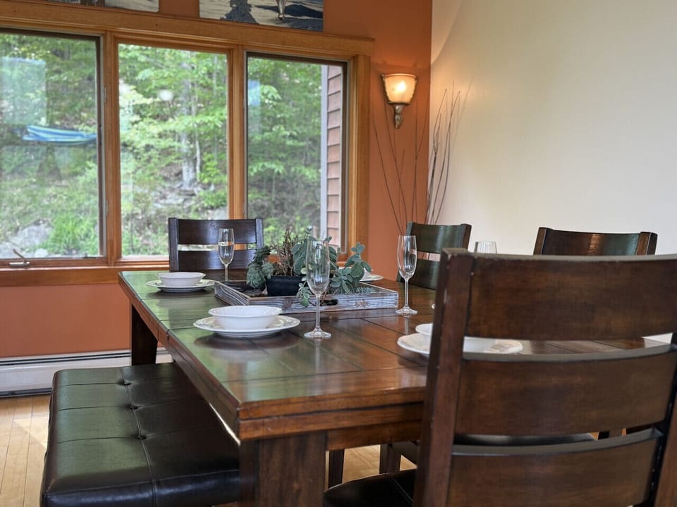 Dining room table set for a meal with mountain views.