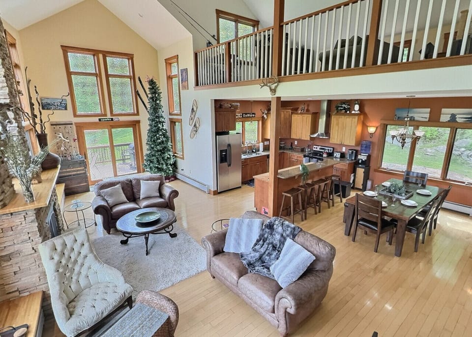 Cozy living room with vaulted ceilings and scenic windows.