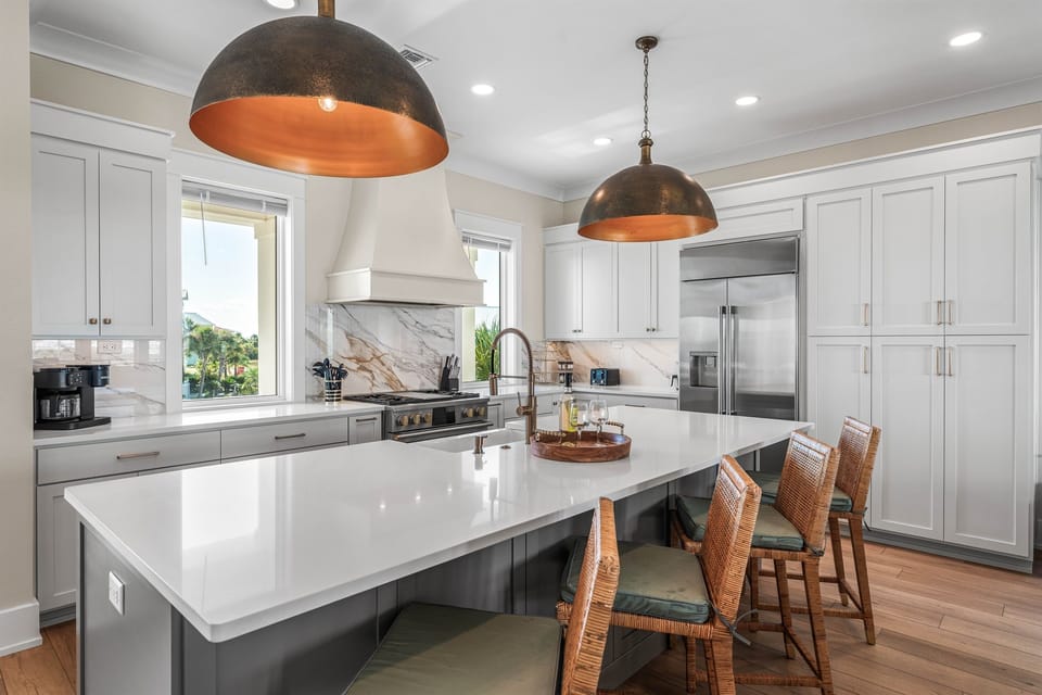 Your spacious kitchen features premium appliances, stunning marble backsplash, and a grand island perfect for cooking and casual dining together.
