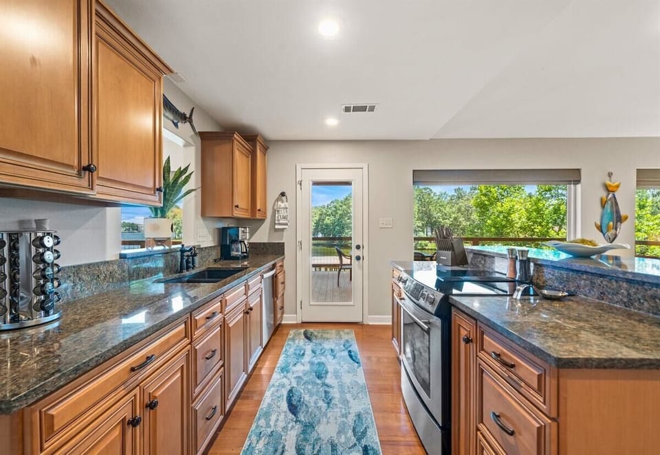 Granite counters, stainless appliances, and lake views make this kitchen a chef's dream.