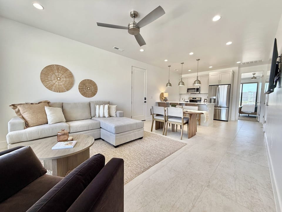 Experience sophisticated comfort in the open-concept living, dining, and kitchen area at Holiday H2 at Catori, Kanab.