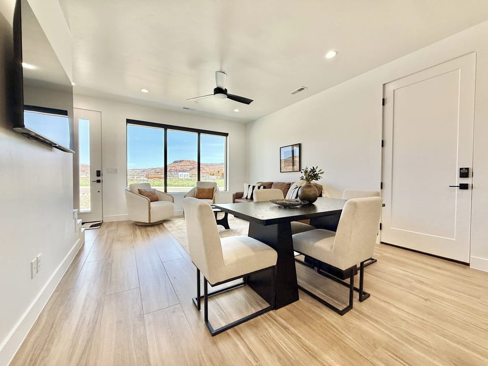 Enjoy luxury and comfort in this open living and dining space with stunning red rock views at Holiday H3 at Catori in Kanab, UT.