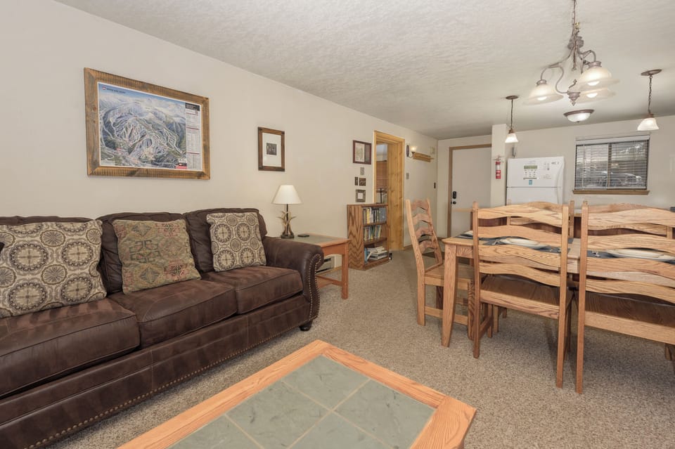 Unwind on cozy leather seating and gather around the rustic dining table in this welcoming mountain retreat.