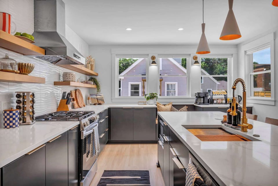 Bright & Stylish Gourmet Kitchen. With sleek countertops, modern appliances, and an inviting window view, this kitchen offers a perfect space for preparing meals and enjoying moments of relaxation during your stay.
