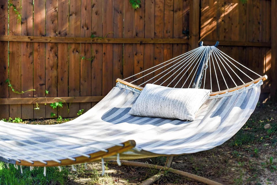 Swing into serenity in a backyard hammock—an ideal nook for reading, sipping coffee, or afternoon naps.