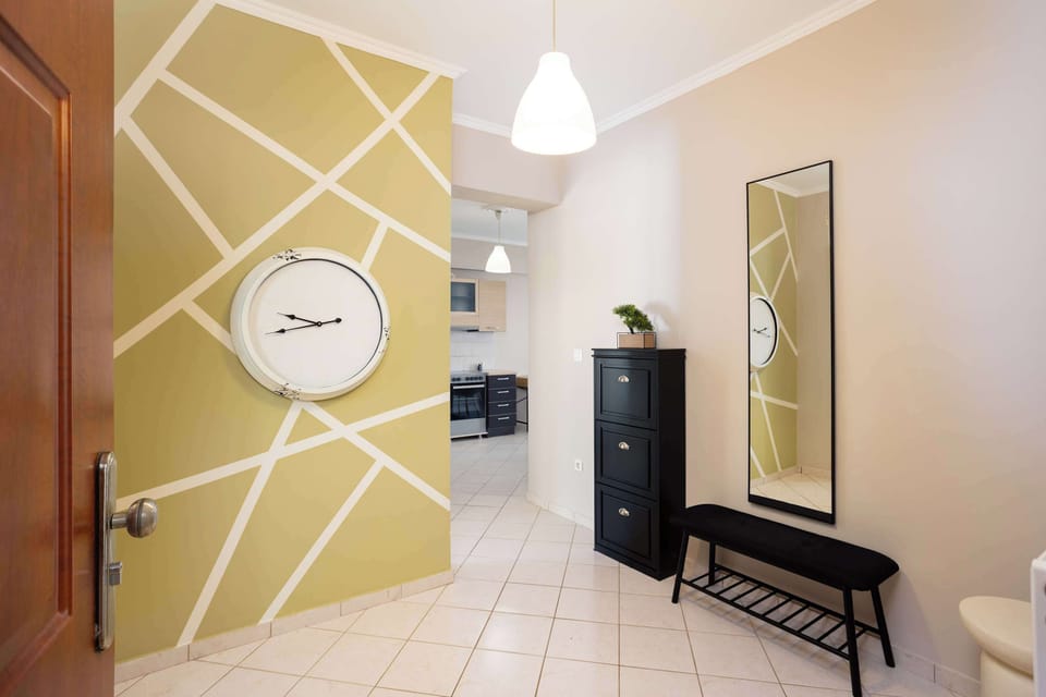 Stylish Entrance Hall with Geometric Wall Decor and Full-Length Mirror

