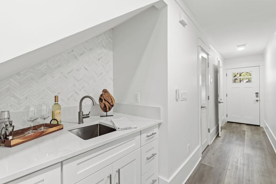 Your sleek kitchen features marble backsplash, quartz counters, and modern appliances perfect for preparing meals during your stay.