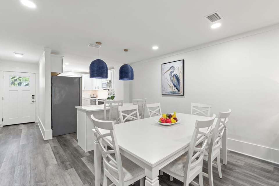 Gather around your spacious dining table for memorable meals together in this bright, modern space with stylish pendant lighting.