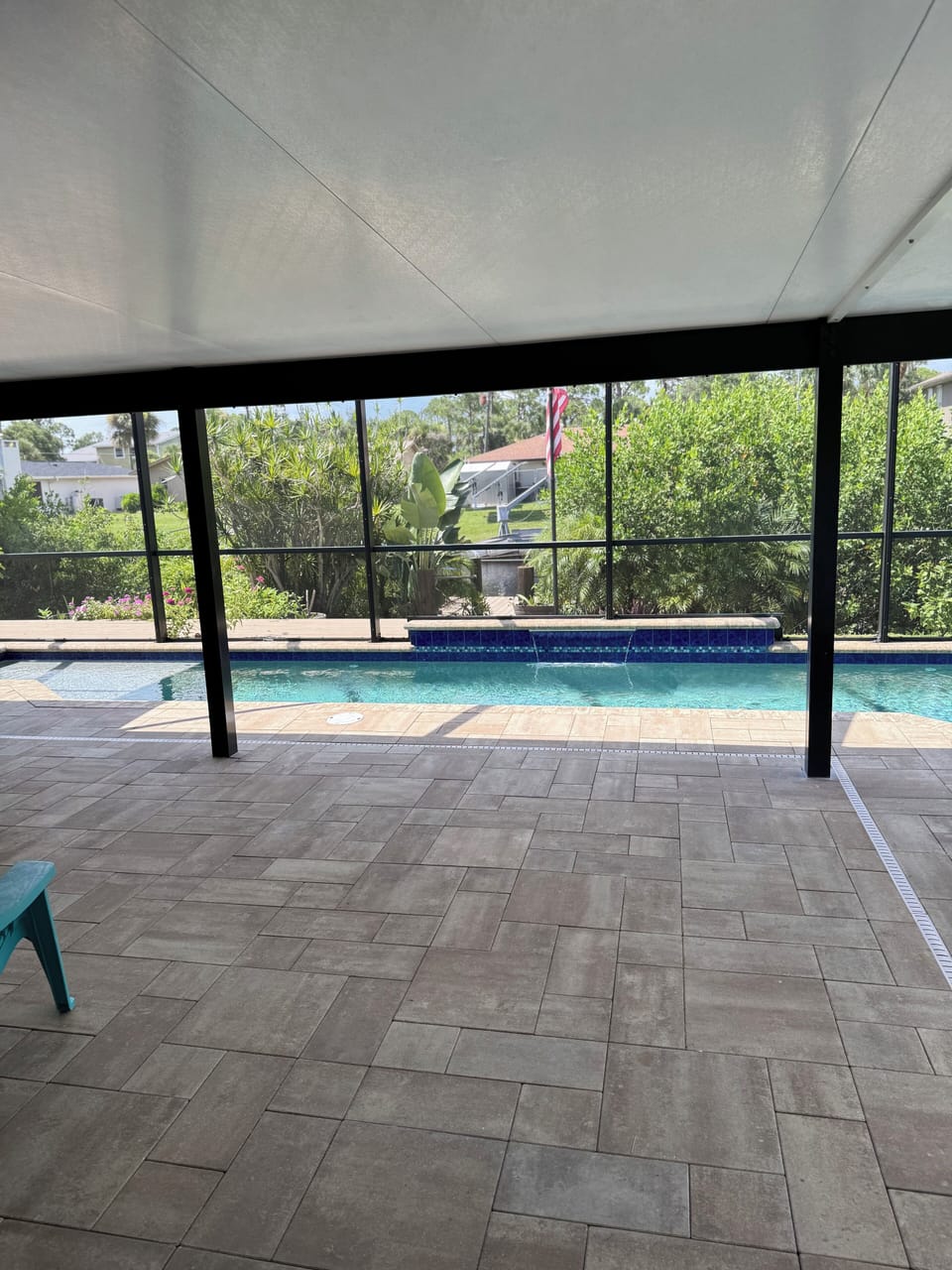 Undercover lanai. Screen, shade with pool waterfall view. 