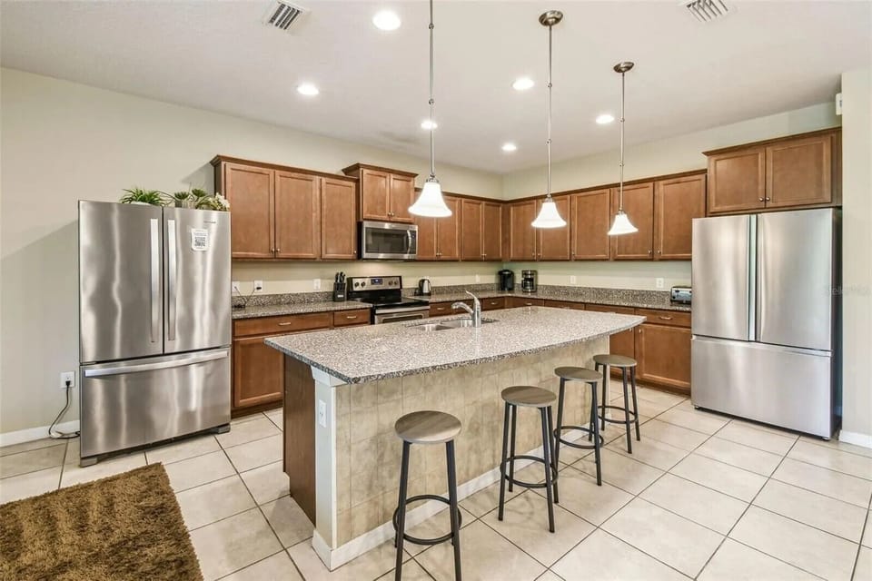 Two full-size refrigerators in the kitchen