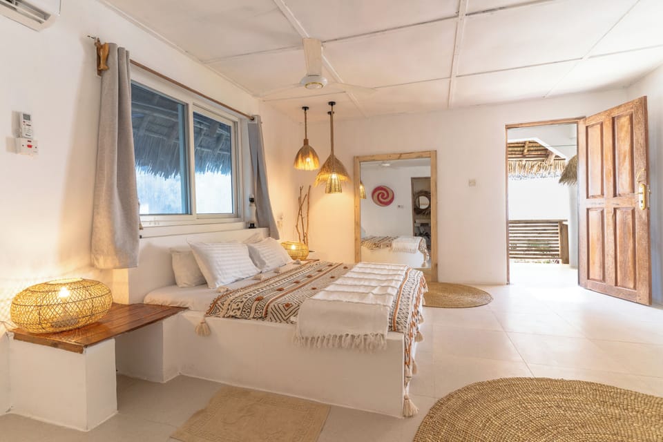 Bright boho bedroom with warm lighting and breezy indoor-outdoor charm