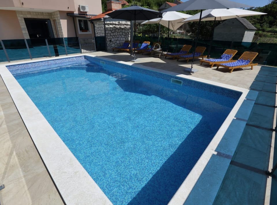 House (Five Bedroom Holiday Home) | Outdoor pool | Outdoor pool, pool umbrellas, sun loungers