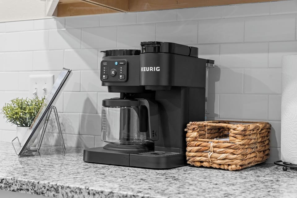 Dual K-Cup and Drip Coffee maker with starter coffee k-cups and creamer.