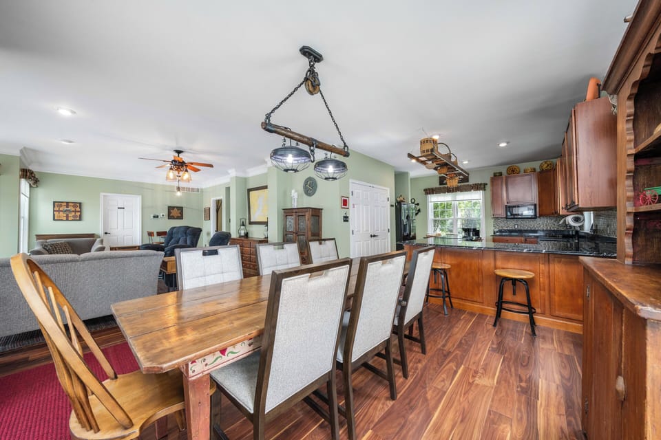 Main floor open concept seating areas: dining, game table, central and peninsula