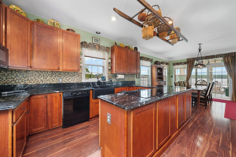 Roomy kitchen, dining room and sunroom with west and north window river views