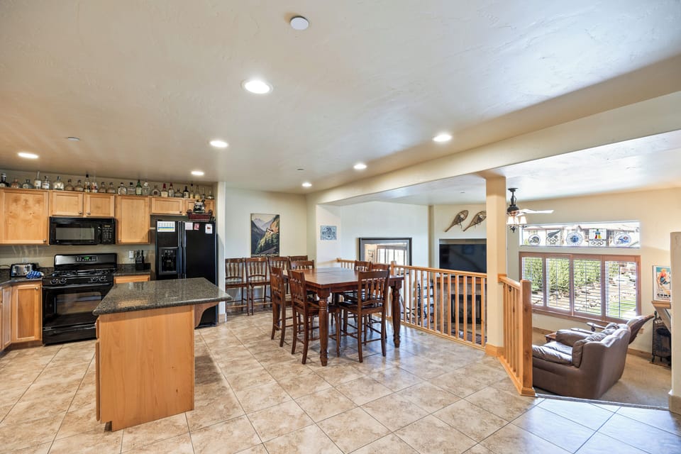 - Spacious kitchen with granite island and modern appliances  
- Dining table for group meals and family gatherings  
- Open layout connects kitchen to living area for easy hosting