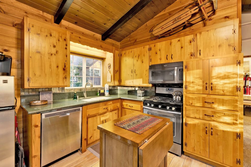 Fully equipped kitchen with stainless steel appliances, ample counter space, and warm wood cabinetry everything you need to cook like home.