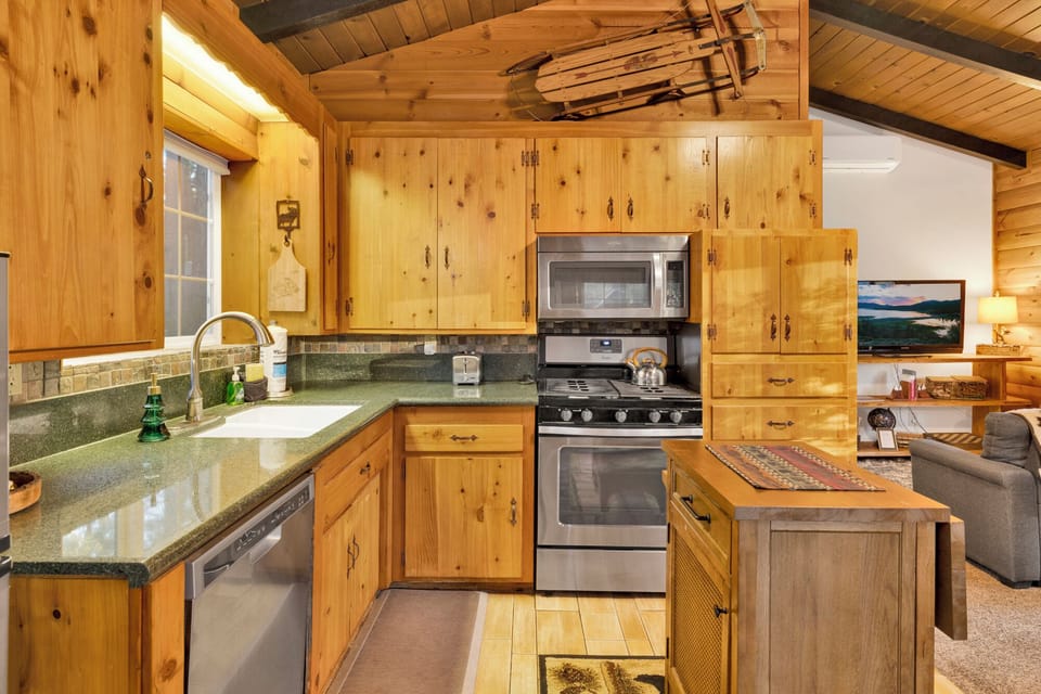 Fully equipped kitchen with stainless steel appliances, ample counter space, and warm wood cabinetry everything you need to cook like home.